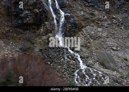 aerial view of a seasonal waterfall in the mountains in Northern California cascading down a rocky hillside Stock Photo