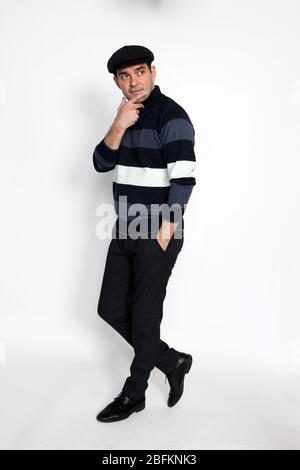 Handsome middle aged man posing in studio on isolated background. Style, elegance, business, gentleman, fashion concept. Stock Photo
