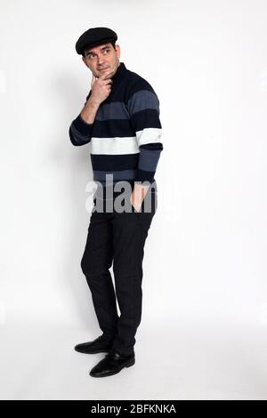 Handsome middle aged man posing in studio on isolated background. Style, elegance, business, gentleman, fashion concept. Stock Photo