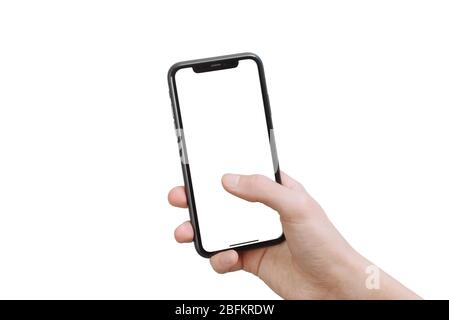 Samara Russia - 04.05.2020: A young man holds an iPhone 11 in his hand and climbs in it. Smartphone mockup. Isolated on white background. Stock Photo