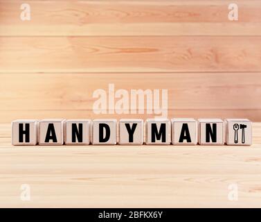 Word Handyman made with cubes on wooden background Stock Photo