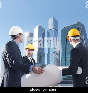 Engineering and architecture concept, engineers working on a building site holding blueprints , architects and engineers inspection in workplace for a Stock Photo