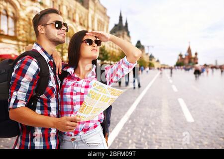 Tourists with map on street in city Stock Photo