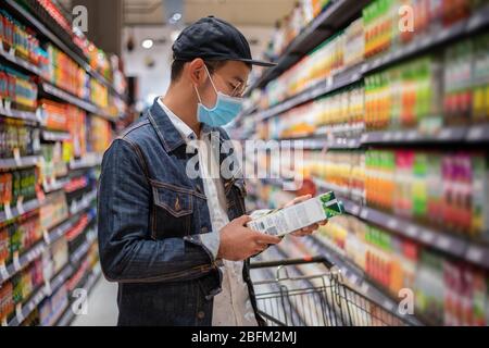 Asian men buy and shopping food  for hoarding in during the Covid outbreak Stock Photo