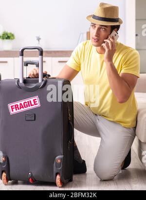 The man going on vacation with fragile suitcases Stock Photo