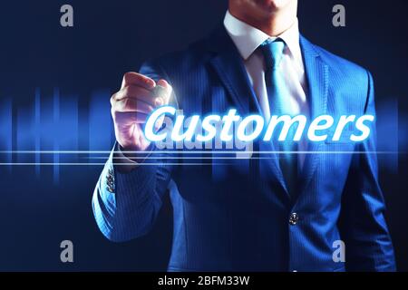 Businessman writing customers on virtual screen. Internet and networking concept. Stock Photo