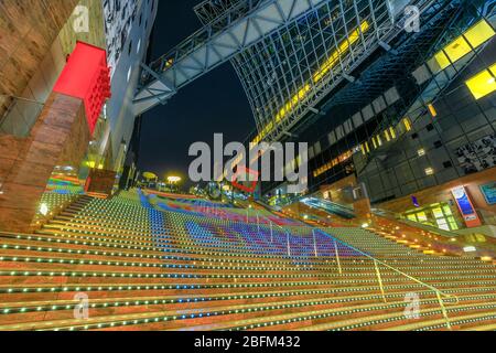 Kyoto, Japan - April 27, 2017: View from the bottom to the top of Daikaidan Grand Stairway with light effects inside Kyoto Station, a major railway Stock Photo