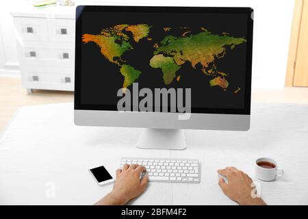 Human working with pc, with world map and network on screen Stock Photo