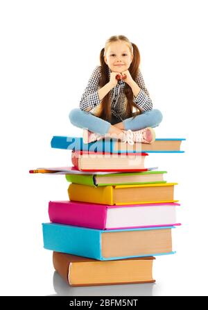 Cute little girl sitting on stack of books isolated on white Stock Photo