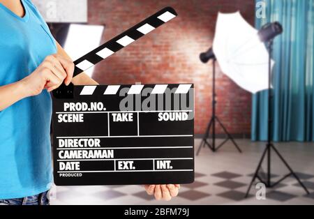 Operator holding clapperboard during the production of film indoors Stock Photo