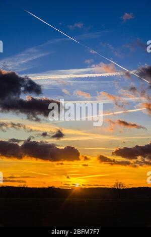 Sunset, clouds and aircraft contrails - central France. Stock Photo