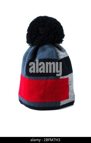 Multi-colored knitted woolen hat with a large pompom Stock Photo