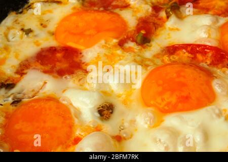 Fried eggs close-up in a pan as a background Stock Photo