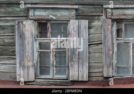 Windows of an old wooden house with shutters Stock Photo