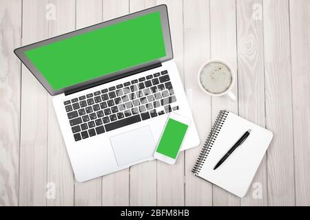 Open notebook, digital tablet and smart phone  on wooden background, top view Stock Photo