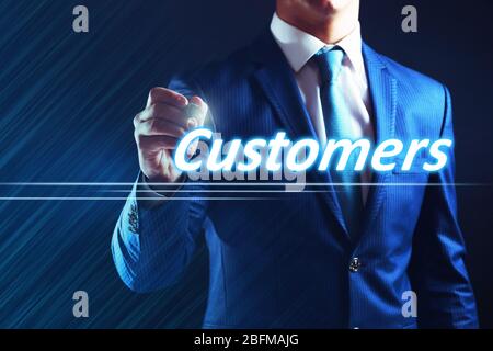 Businessman writing customers on virtual screen. Internet and networking concept. Stock Photo