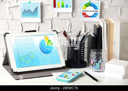 Workplace with tablet-pc with scheme on screen Stock Photo