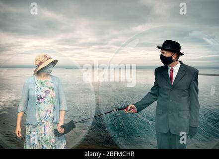 Social isolation. A conceptual photo of a couple social isolating in protective bubbles. Stock Photo
