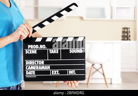 Operator holding clapperboard during the production of film indoors Stock Photo