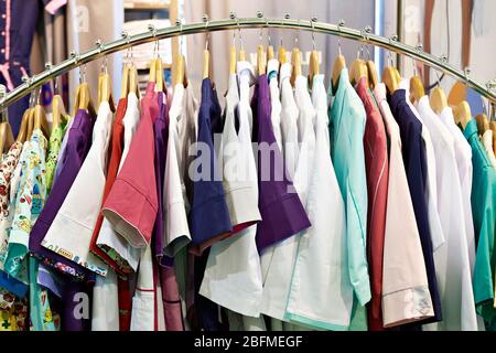 Medical gowns for nurses on a hanger in a store Stock Photo