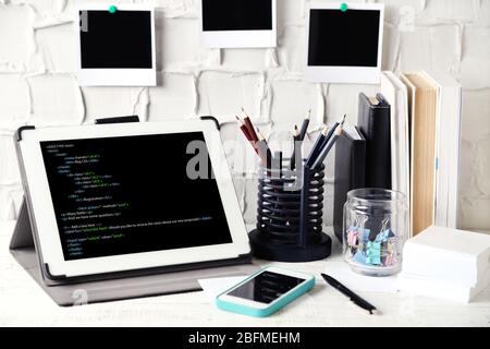 Programming code on tablet computer monitor Stock Photo