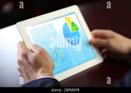 Businessman holding tablet-pc with scheme on screen Stock Photo