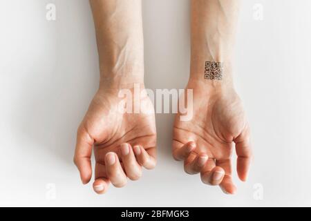 Hand with qr code on wrist. Future of political population control ...