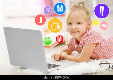 Online shopping. Little girl with laptop in the room Stock Photo