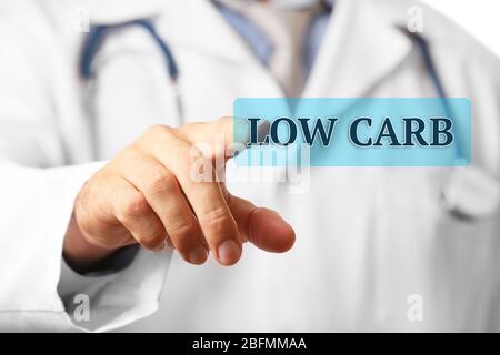 Doctor pointing on Low-Carb button close-up Stock Photo