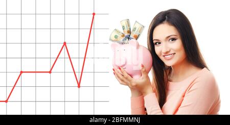 Business accounting concept. Woman with money box and banknotes in it isolated on white Stock Photo