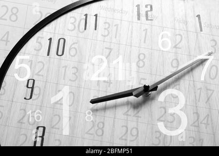 Time is running up concept. Clock face and calendar background. Stock Photo