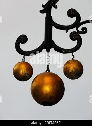 Pawn shop close up of traditional sign of three gold balls above Pawnbroker shop Duncanson and Edwards in Queen street Edinburgh. Stock Photo