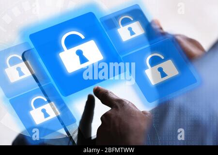 Man working with tablet-pc and icons security on virtual display. Technology, internet and networking concept. Stock Photo
