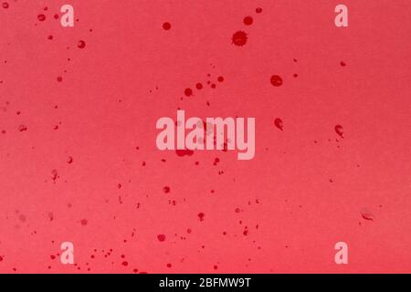 Drop of water on red paper background. Abstract backdrop for your projects. Stock Photo
