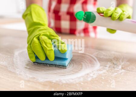 hand in blue rubber glove holding yellow cleaning sponge, cleaning and ...