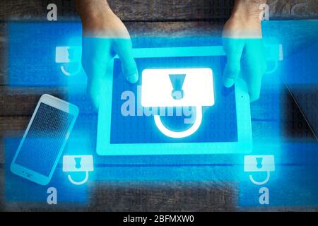Man working with tablet-pc and icons security on virtual display. Technology, internet and networking concept. Stock Photo