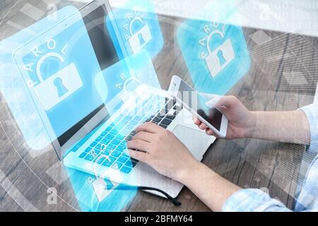 Woman working on laptop with icons security on virtual display. Technology, internet and networking concept. Stock Photo