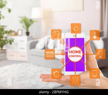 Using smart home app on phone. Smart home control concept. Stock Photo
