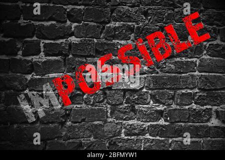 Word impossible transformed into possible on grey wall Stock Photo