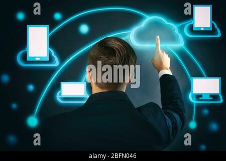 Man pushing touch cloud computing button on virtual screen Stock Photo