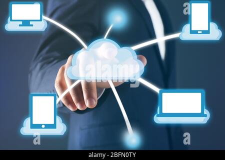 Man pushing touch cloud computing button on virtual screen Stock Photo