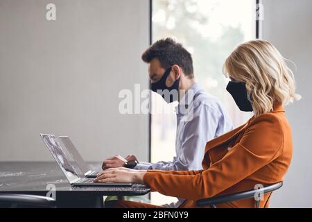 Woman and her coworker sitting in the office Stock Photo