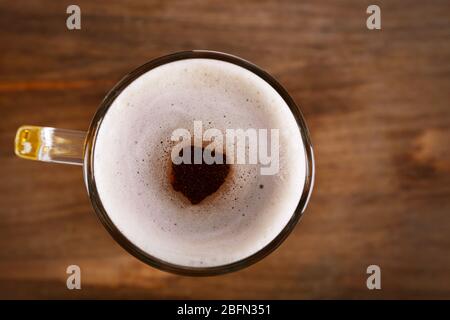 Mug of light beer on wooden background, close up Stock Photo
