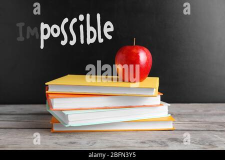 Word impossible transformed into possible on blackboard and textbooks Stock Photo