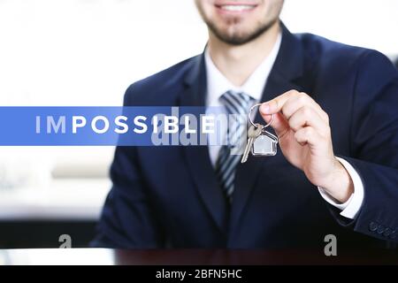 Human hand turning word impossible into possible Stock Photo