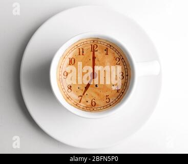 Cup of coffee isolated on white. Time concept Stock Photo