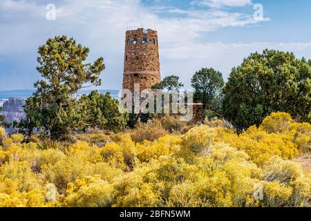 Grand Canyon Desert View Watchtower in autumn with ericameria nauseosa, located on the south rim of Grand Canyon National Park, Arizona. Stock Photo