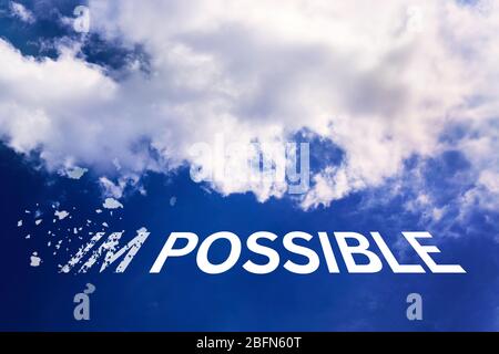 Word impossible transformed into possible on blue sky Stock Photo