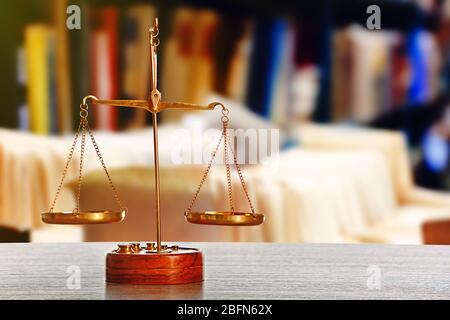 Justice scales on table in library Stock Photo