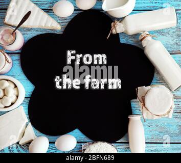 Text From the farm in frame of fresh dairy products on blue wooden table Stock Photo
